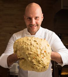 a man holding a large loaf of bread in his hands