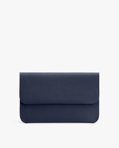 A textured clutch bag with a flap closure against a plain background. Modern On-the-go Satchel Pouch, Versatile Business Clutch, Versatile Top Handle Clutch For Travel, Versatile Business Clutch With Removable Pouch, Versatile Clutch With Removable Pouch For Work, Modern On-the-go Pouch With Detachable Strap, Business Clutch With Removable Pouch, Classic Business Bag With Flat Pocket, Classic Travel Clutch With Detachable Strap