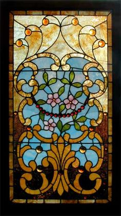 a stained glass window with flowers on it