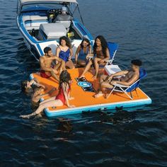 a group of people sitting on an inflatable raft floating on top of the water