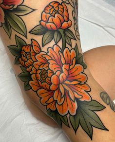 a woman's leg with flowers on it