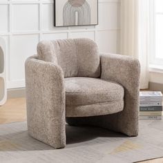 a chair sitting on top of a rug in a living room next to a window