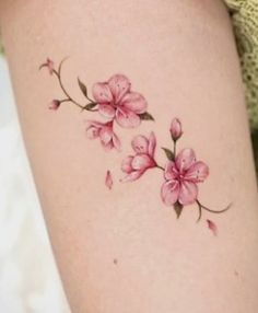 a woman's thigh with pink flowers on it