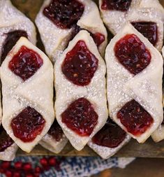 cranberry filled pastries sitting on top of a wooden cutting board