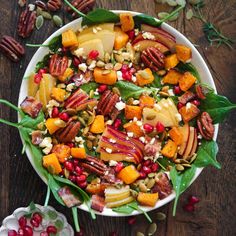 a white bowl filled with fruit and nuts