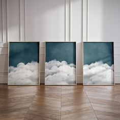 three framed pictures sitting on top of a wooden floor