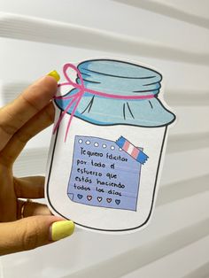 a person holding up a sticker with a jar on it