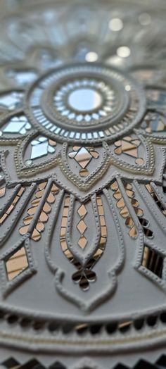 an intricately designed glass plate with decorative designs