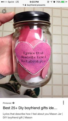 a person holding a jar filled with pink paper hearts and saying it's that describe how i feel about you