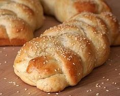 sesame seed bread rolls on a cutting board