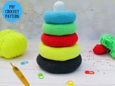 crochet toys are stacked on top of each other with yarn and scissors nearby