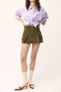 Micro-mini skirt look with lining shorts underneath Faux pocket on the sides Product Specification 97% Cotton 3% Spandex Flat measurement (XS/S) Waist 34cm / hip 43cm / length 35cm (S/M) waist 35.5cm / hip 41cm / length 33cm Professional Clean Only / Do Not Tumble Dry Model's height is 6' 8" (175cm) Bust 31in Waist 23in Hip 34in and wearing XS/S Made in Korea Stretch Mini Cargo Skirt With Pockets, High Waist Stretch Skort With Pockets, Spring Stretch Mini Skirt With Pockets, Chic Stretch Mini Skirt With Pockets, Trendy Mini Bottoms With Pockets, Cotton Skort With Pockets And Stretch, Relaxed Mini Skort With Built-in Shorts, High Waist Green Mini Skirt With Pockets, Chic Fitted Skirt With Cargo Pockets