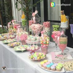 a table topped with lots of desserts and candy