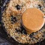 a blender filled with brown liquid on top of a wooden table