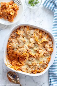 a casserole dish with meat and cheese in it on a marble counter top