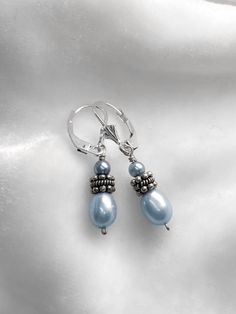 These delicate pearl drop earrings are made with baby blue freshwater pearls (5mm), teeny baby blue  accent pearls (3mm) and sterling silver beads and wires. The ear wire style is lever-back, ensuring that the earring won't fall out and get lost! All of my jewelry is designed with causal elegance in mind. Dressy enough to wear with a dress and heels, but also the perfect match with a weathered t-shirt and jeans. Thanks for your interest 🖤 Blue Teardrop Pearl Drop Earrings, Blue Dangle Pearl Drop Earrings, Blue Pearl Drop Dangle Earrings, Blue Teardrop Sterling Silver Pearl Earrings, Freshwater Pearl Drop Earrings, Blue Accent, Beads And Wire, Blue Accents, Pearl Drop Earrings