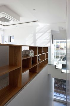 an empty room with wooden shelves on the wall