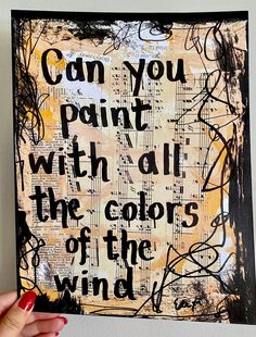 someone holding up a piece of art that says can you paint with all the colors of the wind?