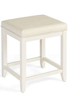 a white stool with a padded seat on the top and bottom part of the foot rest