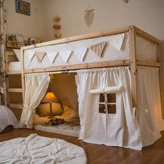 a bunk bed with curtains on the top and bottom