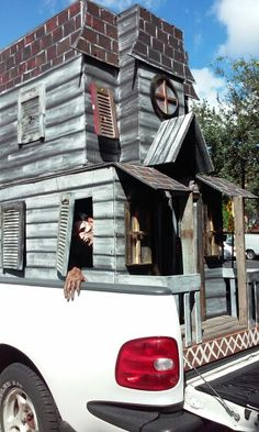 there is a truck with a house on the back and windows in the bed area