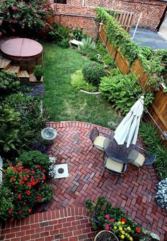 small backyard garden with brick patio and seating area