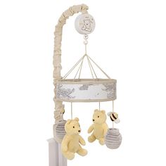 a baby crib mobile with two teddy bears hanging from it