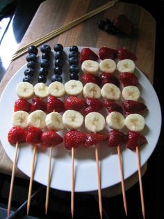 an american flag made out of bananas and strawberries on a plate with chopsticks