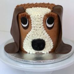 a cake shaped like a dog's head with eyes