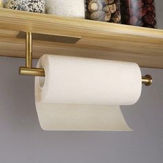 two rolls of toilet paper are hanging on the shelf