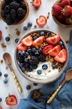 a bowl filled with yogurt, berries and granola