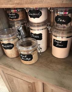 some jars with labels on them sitting on a shelf