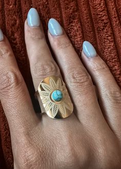 Adjustable Gold Oval Flower Stamped Concho Ring with Turquoise Accents. (Not Authentic) Blue Bohemian Rings For The Beach, Blue Bohemian Rings For Beach, Bohemian Blue Rings For Beach, Bohemian Oval Jewelry For The Beach, Bohemian Oval Jewelry For Beach, Gold Bohemian Turquoise Open Ring, Bohemian Gold Turquoise Open Ring, Adjustable Bohemian Blue Flower Ring, Jewlery Earrings