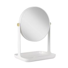 a white table top mirror on a stand