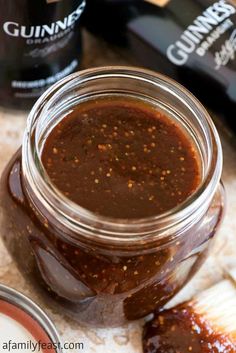 a jar filled with barbecue sauce sitting on top of a table