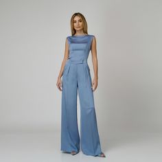 A harmonious blend between comfort and sophistication, our Skye Silk Wide-Leg Pants redefine elegance with every step. Impeccably tailored from blue double silk satin, they present a flattering high-waist with expertly placed darts and a wide-leg cut with a pressed crease detail which visually elongates the silhouette. The concealed zipper and hook fastening in the front ensures ease of wear and a seamless finish.  Match: Complete the look with the Skye Silk Camisole.  Each Il Volo item is handmade by skilfull artisans in our Bucharest atelier and it is created in limited series. 100% Italian Double Silk Satin.  Gentle dry clean. Do not wash. Do not use chlorine based bleach. Do not tumble dry. Cool iron, max 110 C.  Made in EU. Blue Satin Bottoms For Formal Occasions, Elegant Wide Leg Satin Pants For Formal Occasions, Elegant Satin Wide Leg Pants For Formal Occasions, Formal Blue Satin Bottoms, Elegant Satin Wide Leg Pants, Elegant Satin High-waisted Wide Leg Pants, Elegant Wide Leg Silk Pantsuit, Elegant Silk Pantsuit With Trousers, Elegant Silk Trousers Pantsuit