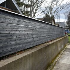 a wooden fence on the side of a house