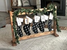 stockings hanging from a wooden frame with christmas decorations on them in front of a fireplace