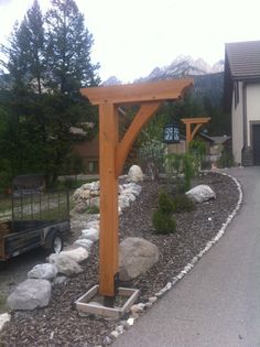 a large wooden structure sitting in the middle of a driveway