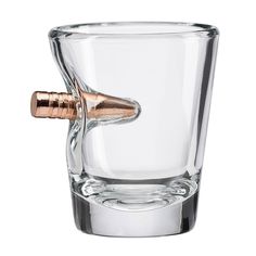 a shot glass with a metal tip in it