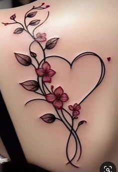 the back of a woman's stomach with flowers and leaves on it, as well as a heart