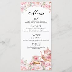 a menu card with pink flowers and teapots on the front, sitting on a marble surface