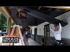 two men working on the roof of a building