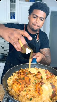 a man pouring sauce on food in a pan