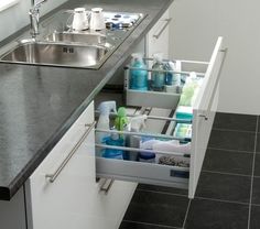 an open drawer in the middle of a kitchen counter