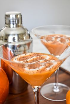 two martini glasses filled with an orange drink