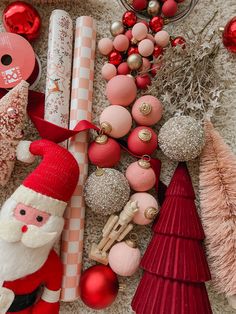 christmas decorations and ornaments are arranged on the floor