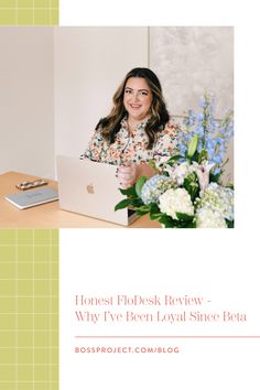 a woman sitting in front of a laptop computer on top of a desk with flowers