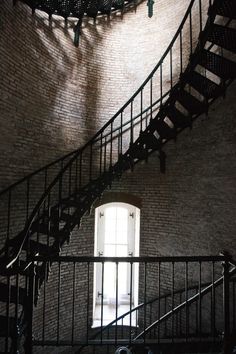 a spiral staircase in an old brick building