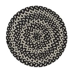 a black and white circular rug on a white background